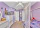 This bedroom showcases a TV, large dresser, and a four-poster bed at 513 Woodson Dr, Clayton, NC 27527