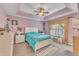 Bright bedroom with tray ceilings, ceiling fan and neutral carpet at 513 Woodson Dr, Clayton, NC 27527