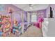 Bright, whimsical bedroom with purple walls, canopy bed, and playful decor at 513 Woodson Dr, Clayton, NC 27527