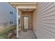 Welcoming front entrance with a brick wall, neutral siding, and a neatly kept landscape at 513 Woodson Dr, Clayton, NC 27527