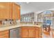 Well-lit kitchen area featuring wooden cabinets, updated appliances, and a view into the dining room at 513 Woodson Dr, Clayton, NC 27527