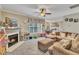 Cozy living room with a fireplace, large window, comfortable seating, and an open floor plan at 513 Woodson Dr, Clayton, NC 27527