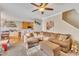 Bright living room with plush sectional, ceiling fan, and an open layout into the dining area at 513 Woodson Dr, Clayton, NC 27527