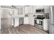 Modern kitchen featuring white cabinets, stainless steel appliances, and quartz countertops at 5505 Crabtree Park Ct, Raleigh, NC 27612