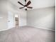 Spacious carpeted main bedroom featuring a ceiling fan and an ensuite bathroom at 5505 Crabtree Park Ct, Raleigh, NC 27612