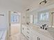 Elegant primary bathroom with double vanity, granite countertops, soaking tub, and views through an adjacent bedroom at 5545 Silk Hope Gum Springs Rd, Siler City, NC 27344