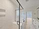 Luxurious bathroom featuring white subway tile, marble floors, a glass-enclosed shower, and a soaking tub at 5545 Silk Hope Gum Springs Rd, Siler City, NC 27344