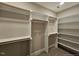 Spacious walk-in closet with custom shelving and rods for organized storage solutions and convenience at 5545 Silk Hope Gum Springs Rd, Siler City, NC 27344