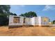 Home under construction showcasing the initial framing, brick foundation, and structural design on a sunny day at 5545 Silk Hope Gum Springs Rd, Siler City, NC 27344