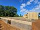 Image displays the brick foundation and framing work in progress on a new home construction site at 5545 Silk Hope Gum Springs Rd, Siler City, NC 27344