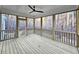 Relaxing screened porch with wood flooring, offering an outdoor living space to enjoy views of nature at 5545 Silk Hope Gum Springs Rd, Siler City, NC 27344