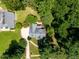 An aerial view of a home with mature trees and a circular driveway nestled in a lush, green neighborhood at 5940 Dahlberg Dr, Raleigh, NC 27603
