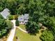 Aerial view of property with lush greenery, circular driveway and landscaped grounds at 5940 Dahlberg Dr, Raleigh, NC 27603