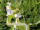 An aerial view of a home with mature trees and a circular driveway nestled in a lush, green neighborhood at 5940 Dahlberg Dr, Raleigh, NC 27603