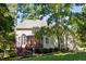A spacious backyard featuring a deck with access to the home's sunroom and a lush lawn at 5940 Dahlberg Dr, Raleigh, NC 27603