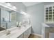 Double vanity bathroom with tile floors and large mirror at 5940 Dahlberg Dr, Raleigh, NC 27603