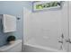 Bright bathroom shower and toilet area with white fixtures and a window at 5940 Dahlberg Dr, Raleigh, NC 27603