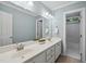 Bathroom with a double sink vanity, a large mirror, and a separate shower/tub area at 5940 Dahlberg Dr, Raleigh, NC 27603