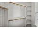 Walk-in closet with wooden racks and shelves, and a small window for natural light at 5940 Dahlberg Dr, Raleigh, NC 27603