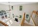 Living room with a fireplace and lots of windows, viewed from the staircase above at 5940 Dahlberg Dr, Raleigh, NC 27603