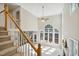 Bright living room featuring soaring ceilings, arched windows, and a cozy fireplace at 5940 Dahlberg Dr, Raleigh, NC 27603