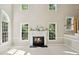Bright living room with a fireplace and large windows providing an abundance of natural light at 5940 Dahlberg Dr, Raleigh, NC 27603