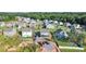 An aerial view of homes in a residential neighborhood with a green forested backdrop at 614 Marian Way, Sanford, NC 27330