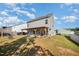The backyard features a partially covered pergola with a grill, great for entertaining guests at 614 Marian Way, Sanford, NC 27330