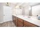 Bathroom featuring double sinks, wood cabinets, and a large mirror for a functional space at 614 Marian Way, Sanford, NC 27330