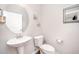 Bathroom featuring a pedestal sink and toilet complemented by neutral walls and modern fixtures at 614 Marian Way, Sanford, NC 27330