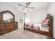 Bedroom featuring wood dresser, bed frame, plush carpet flooring and a ceiling fan at 614 Marian Way, Sanford, NC 27330