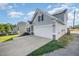 Two-story home with solar panels, a well-manicured lawn, and an attached two-car garage at 614 Marian Way, Sanford, NC 27330
