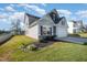Two-story home with solar panels, a well-manicured lawn, and an attached two-car garage at 614 Marian Way, Sanford, NC 27330