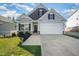Charming single-Gathering home with a well-manicured lawn and attached two-car garage at 614 Marian Way, Sanford, NC 27330