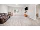 Comfortable living room with plush carpet, a cozy leather sofa, and a mounted TV at 614 Marian Way, Sanford, NC 27330