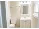 This is a bathroom with a toilet, vanity, and mirror at 621 Reservoir St, Durham, NC 27703