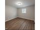 Bedroom with wood-look flooring and neutral paint at 621 Reservoir St, Durham, NC 27703