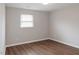 Bedroom featuring wood-look floors, fresh paint, and natural light at 621 Reservoir St, Durham, NC 27703