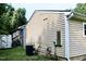 View of the exterior with an air conditioning unit and electrical components at 621 Reservoir St, Durham, NC 27703