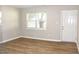 Bright living room with wood-look flooring and a white front door at 621 Reservoir St, Durham, NC 27703