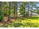An expansive backyard with mature trees, a pool, and a fenced perimeter at 63 Majestic Oak Dr, Garner, NC 27529