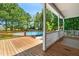 A wood deck features an above-ground pool surrounded by lush greenery and trees at 63 Majestic Oak Dr, Garner, NC 27529
