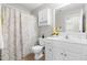 Bathroom vanity with mirror, tile floors, and yellow patterned shower curtain at 63 Majestic Oak Dr, Garner, NC 27529