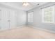 Neutral bedroom featuring carpet, closet, ceiling fan, and natural light from two windows at 63 Majestic Oak Dr, Garner, NC 27529