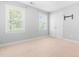Minimalist bedroom featuring carpet, two windows, and double door closet at 63 Majestic Oak Dr, Garner, NC 27529