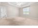 Spacious bedroom with neutral walls, tray ceiling, fan, and natural light at 63 Majestic Oak Dr, Garner, NC 27529