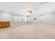 Spacious bonus room boasts a ceiling fan, windows, and custom wood cabinetry at 63 Majestic Oak Dr, Garner, NC 27529