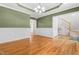 Bright dining room with hardwood floors, wainscoting, and modern light fixture at 63 Majestic Oak Dr, Garner, NC 27529