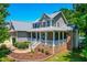 Beautiful two-story home boasts mature trees, brick accents, and a welcoming front porch, perfect for relaxation at 63 Majestic Oak Dr, Garner, NC 27529