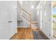 Bright foyer with hardwood floors, staircase, and decorative front door at 63 Majestic Oak Dr, Garner, NC 27529